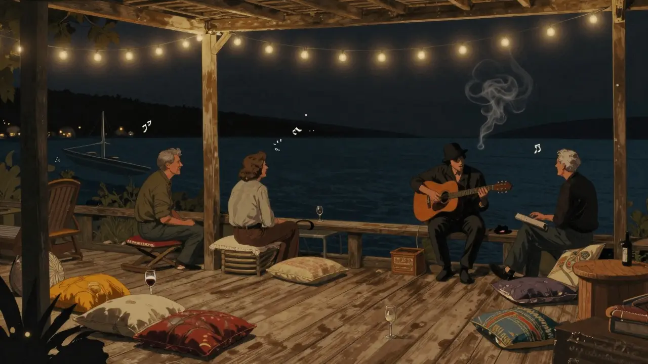 Le Club 55 at night: wooden deck, string lights, and a guitarist playing by the water.